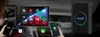 A car's dashboard with a large screen displaying apps, and two smartphones connected wirelessly. Produktbild-Vorschau