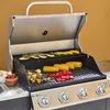 A gas grill with food cooking on it, set against a plain background. Produktbild-Vorschau