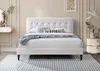 A white upholstered bed with a tufted headboard is shown in a bedroom setting. Náhľad obrázku produktu