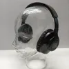 A pair of black JBL headphones is displayed on a clear glass mannequin head. Produktbild-Vorschau