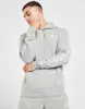 A man wearing a grey Nike tracksuit. Produktbild-Vorschau