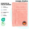 A stack of pink bath mats of varying sizes, with text and icons on the left side detailing product features. Náhled obrázku produktu