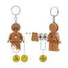 Diagram showing how to assemble and use a LEGO gingerbread man keychain with LED lights and batteries. Produktbild-Vorschau