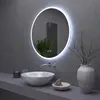 A modern bathroom vanity with a round LED mirror, a vessel sink, and decorative items. Náhled obrázku produktu