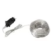 A string of warm white LED lights coiled on a spool, connected to a black power adapter with a European plug. Produktbild-Vorschau