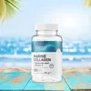 A bottle of OstroVit Marine Collagen supplement is placed on a wooden surface with a beach and ocean background. Náhľad obrázku produktu