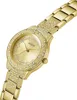 A close-up, angled view of a gold-colored Guess watch with crystal embellishments. Podgląd zdjęcia produktu
