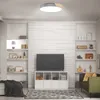 A modern living room with a TV, shelves, and a sofa. Voir les images du produit