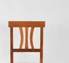 Close-up of the back of a wooden chair. Voir les images du produit