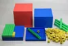 A collection of math manipulatives, including large cubes, flat boards, and small cubes, in red, blue, green, and yellow. Anteprima dell’immagine prodotto