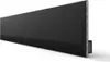 A close-up, angled view of a black soundbar with silver trim, mounted on a white background. Podgląd zdjęcia produktu