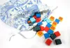 A drawstring bag with a blue and white pattern is open, spilling out colorful square tiles. Produktbild-Vorschau