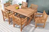 A wooden dining set with a table and chairs on a wooden deck. Produktbild-Vorschau