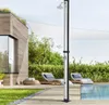 An outdoor shower by a modern house and pool area with lounge chairs. Náhled obrázku produktu