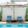 A patio umbrella is set up over two lounge chairs next to a swimming pool. Anteprima dell’immagine prodotto
