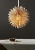 A paper star lantern hangs above a table covered with a white cloth, with a bowl of nuts and dried fruit in the foreground. Podgląd zdjęcia produktu