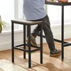 A person sitting on a bar stool next to a bar table. Produktbild-Vorschau