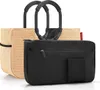 A straw-like shopper bag with black handles and a black insert bag. Produktbild-Vorschau