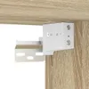 A close-up view of a white metal bracket attached to a wooden surface, likely part of a cabinet or shelf mounting system. Produktbild-Vorschau