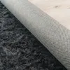 Close-up view of the underside and pile of a shaggy rug. Anteprima dell’immagine prodotto