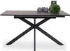 A modern dining table with a dark ceramic-look tabletop and black metal legs, styled with decorative items on top. Náhled obrázku produktu