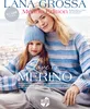 A mother and daughter are sitting together, both wearing matching striped sweaters and the daughter is wearing a hat. They are outdoors, possibly near a beach. Produktbild-Vorschau