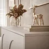 A close-up of a white dresser with decorative items on top. Produktbild-Vorschau