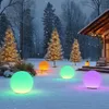 A snowy garden scene at night with illuminated spherical lights and decorated Christmas trees. Produktbild-Vorschau