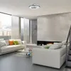A modern living room with a fireplace, sofas, and a coffee table. Podgląd zdjęcia produktu