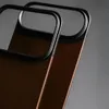 A close-up shot of two phone cases, showing their metallic and leather details. Anteprima dell’immagine prodotto