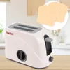 A toy toaster with two toy toasts is shown on a wooden surface with a blurred kitchen background. Anteprima dell’immagine prodotto