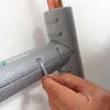 A hand is shown securing pipe insulation with a zip tie. Produktbild-Vorschau