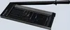 A black paper cutter with measurement markings on its surface, shown from a slightly elevated angle. Produktbild-Vorschau