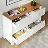 A white sideboard with a wooden top, featuring multiple open drawers filled with various items. Anteprima dell’immagine prodotto