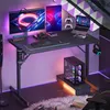 A gaming desk setup with a computer, monitors, and accessories, illuminated by LED lighting. Anteprima dell’immagine prodotto