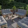 An outdoor seating area with pallet furniture and cushions. Voir les images du produit