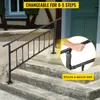 A black metal handrail installed on outdoor concrete steps, with a close-up inset showing a hand gripping the rail. Anteprima dell’immagine prodotto