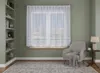 A living room scene with a window covered by white curtains, a bookshelf, a chair, and a rug. Náhled obrázku produktu