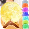 A collage of a moon-shaped humidifier and diffuser with multiple color options displayed in a row. Podgląd zdjęcia produktu