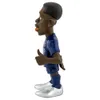 A side view of a cartoon-like figurine of a soccer player. Anteprima dell’immagine prodotto