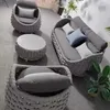 A set of outdoor furniture, including two armchairs, a sofa, and a coffee table, arranged on a floor. Produktbild-Vorschau