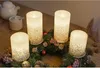 Four LED candles with glitter accents are arranged on a Christmas wreath with pinecones and berries. Produktbild-Vorschau