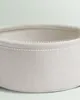 Close-up view of the top rim of a round fabric storage basket. Náhled obrázku produktu