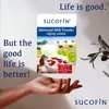A hand is holding a product packaging with a scene of cows and strawberries on it. Text is overlaid on the image. Produktbild-Vorschau