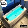 A modern bathroom with a lit bathtub and a bath plug shown in a close-up inset. Produktbild-Vorschau