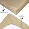 A close-up view of a beige fitted sheet, showing its texture and elastic band. Produktbild-Vorschau