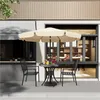 An outdoor cafe setting with a table, chairs, and umbrella. Produktbild-Vorschau