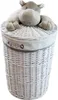 A white wicker laundry basket with a plush hippo toy on top. Náhľad obrázku produktu