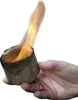 A hand holding a burning fire starter. Produktbild-Vorschau