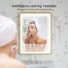 A woman is looking into a lighted mirror in a bathroom. The mirror has text overlaying the top. Náhled obrázku produktu